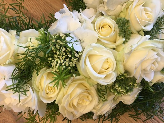 Heart-shaped funeral tribute with white luxury flowers and foliage, created as a tribute to Manchester.