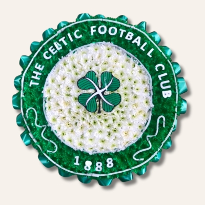 Celtic badge funeral tribute with white chrysanthemum base, green spray detail, laminated accents and green ribbon edging, 23 inch, ideal for Celtic FC fans.