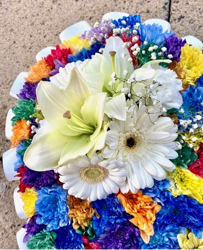 Intricate heart-shaped funeral tribute with sprayed chrysanthemum, white ribbon edge, and white focal flowers.