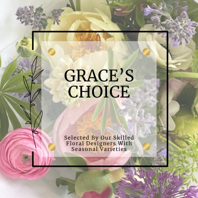 Seasonal bouquet in pink, white and pastel tones arranged in a loose wild garden style, hand-tied in water and presented in a luxury gift bag.