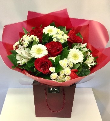 Red and white romantic flower bouquet, hand-tied and gift wrapped.