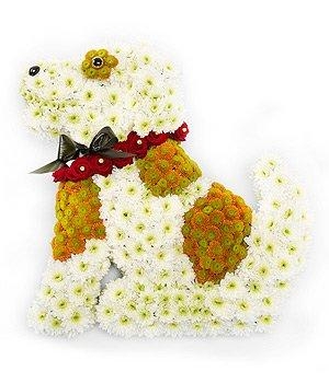 Sitting dog-shaped funeral tribute made with white and bronze chrysanthemums, finished with a red rose collar and accent detailing, measuring approximately 58cm x 53cm.