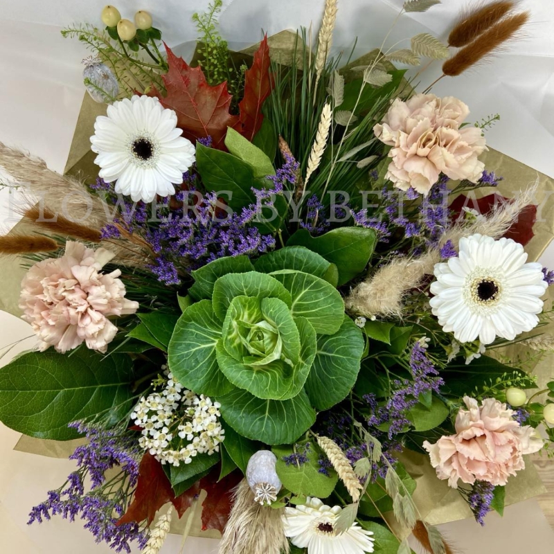Woodland Whisper bouquet with white gerbera, blush carnations, berries and autumn grasses in natural gift wrap.