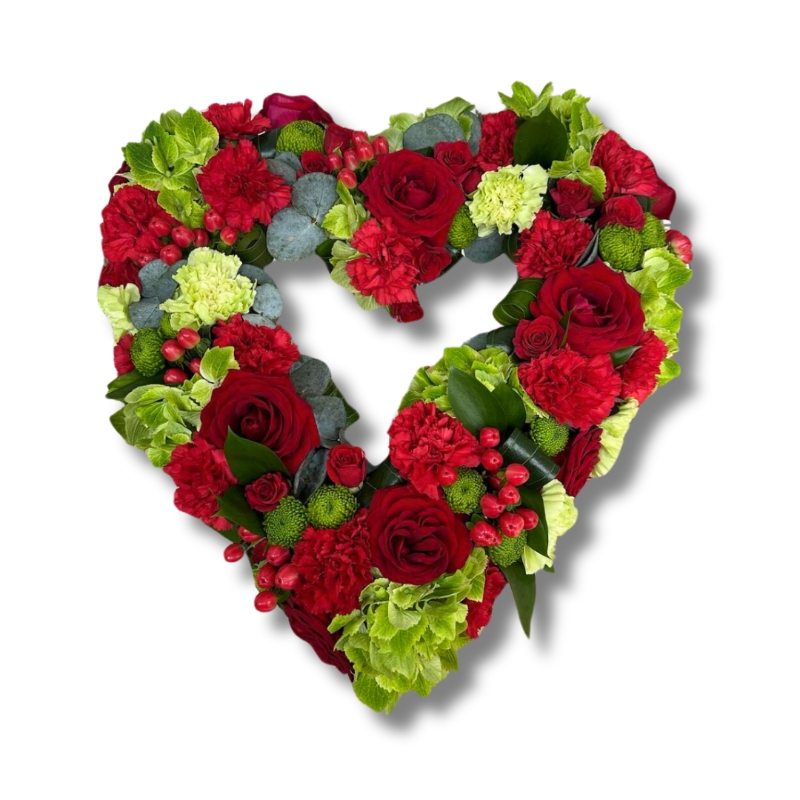 Cherry heart funeral tribute in red and green with luxury floral varieties and seasonal accents.