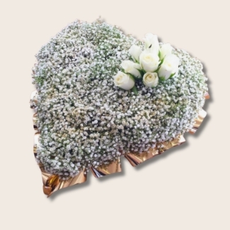 Funeral heart tribute of white gypsophila with gold glitter, gold ribbon edging, and a white rose focal point.