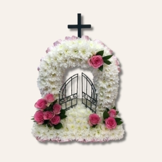 Gates of Heaven funeral tribute with white chrysanthemum base and pink floral focal, 20 x 18 inches, customisable ribbon and flower colours.