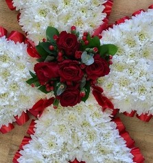 Maltese Cross funeral tribute with white chrysanthemum base, red ribbon edging and red floral focal, 22 x 22 inches, customisable colours available.