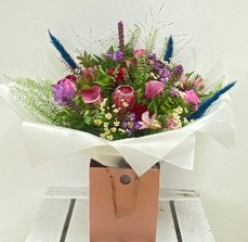 Ruby Jewel bouquet with roses, calla lily, clematis, liatris and pampas grass in jewel-toned shades.