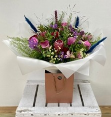 Ruby Jewel bouquet with roses, calla lily, clematis, liatris and pampas grass in jewel-toned shades.