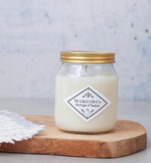 The Naked Candle Co Pink Pepper & Mandarin soy candle in a glass jar.
