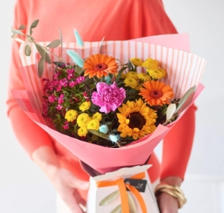 Bright colourful summer bouquet with florist’s choice seasonal florals in orange pink and yellow tones by Flowers by Bethany Leigh florist