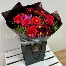 Sparkling red Valentine’s bouquet with diamanté detail and butterfly accent.