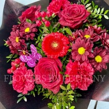 Sparkling red Valentine’s bouquet with diamanté detail and butterfly accent.