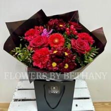 Sparkling red Valentine’s bouquet with diamanté detail and butterfly accent.