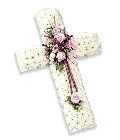 Massed white chrysanthemum cross with pleated ribbon and seasonal flowers in customizable colors.