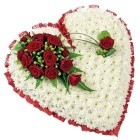 Heart-shaped funeral tribute massed with white chrysanthemums, featuring a focal of mixed seasonal flowers and foliage. Customizable colour options available.