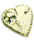 Classic heart-shaped funeral tribute with white chrysanthemums, featuring a mix of seasonal flowers to create a focal point. Customizable colour options available.
