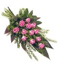  Pink rose funeral spray with greenery and a natural bow.