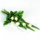 White rose funeral spray with modern foliage arrangement.